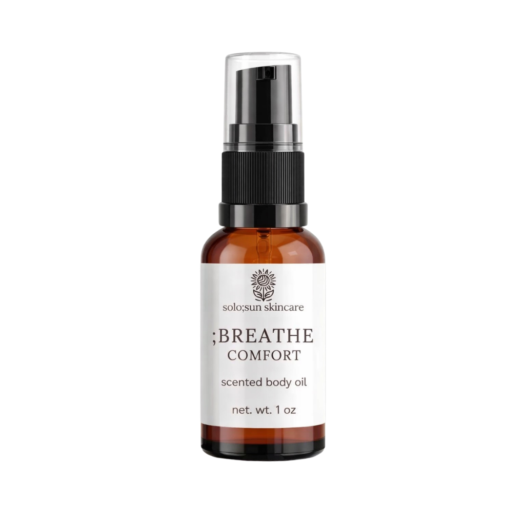 Bottle of solo;sun skincare scented body oil on a white background