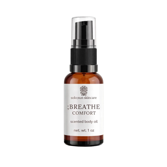 Bottle of solo;sun skincare scented body oil on a white background
